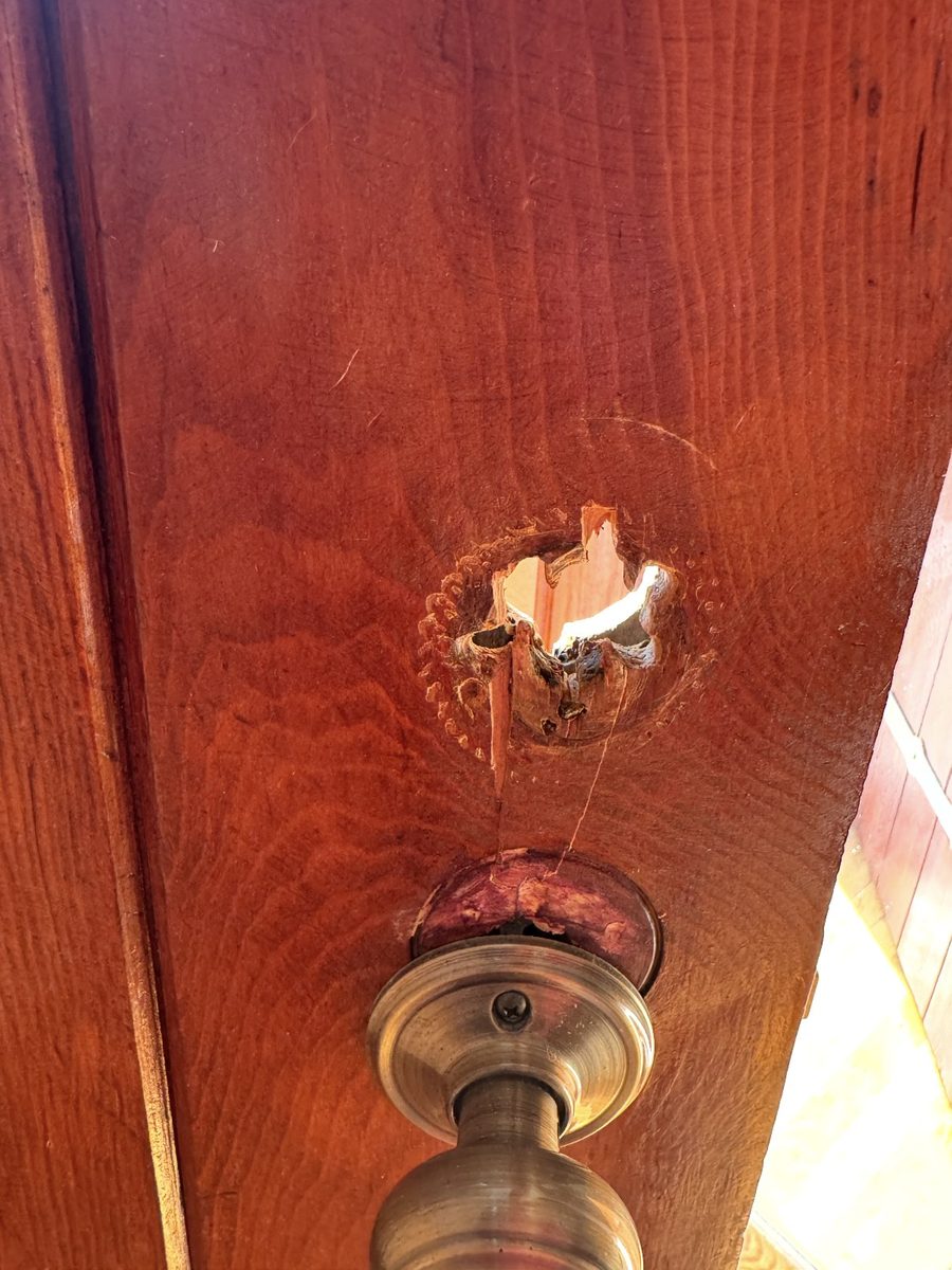 The torn-out cylinder hole left behind when a mortise lock comes out