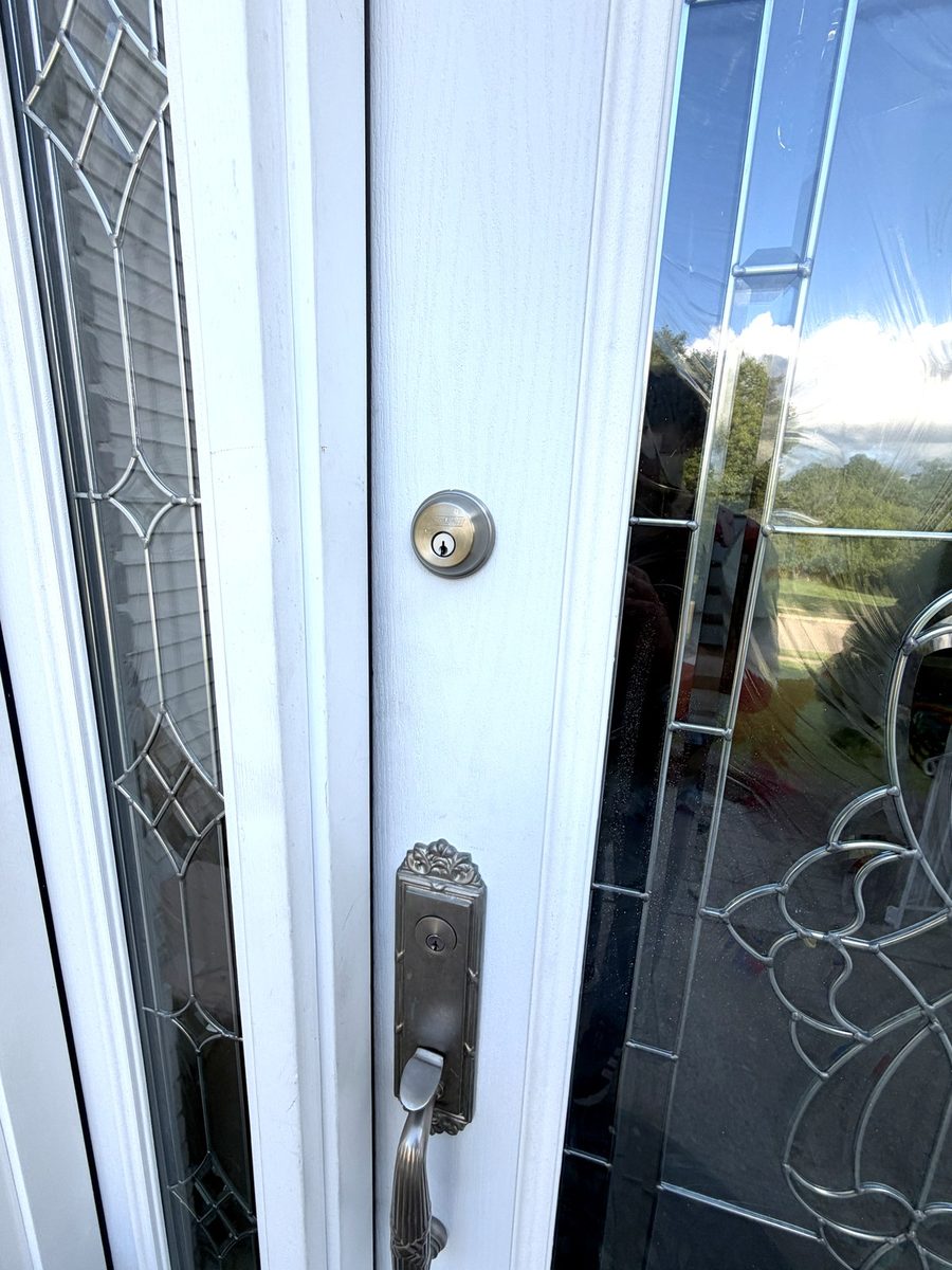 A decorative glass entry door with matching hardware