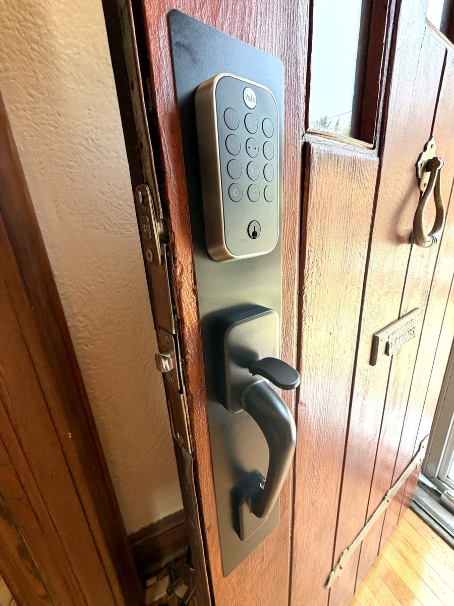 A keypad deadbolt fitted above a handleset on a real front door